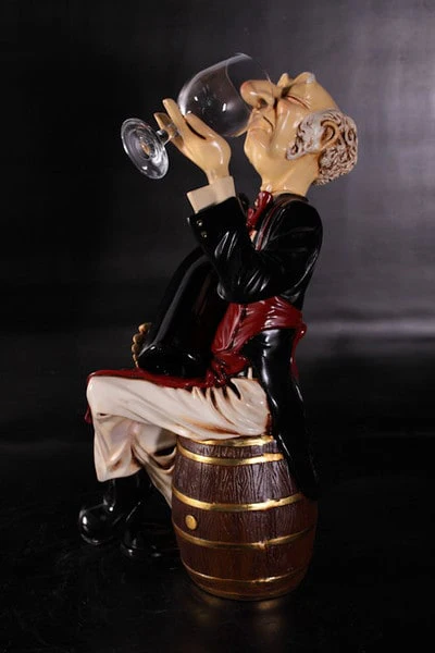 Wine Connoisseur Sitting On Barrel